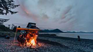 Gears of Travel, Canadian adventure | Chevrolet with canopy camper next to campfire