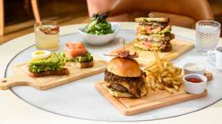 New York City | A hamburger and other menu items at Fig & Olive