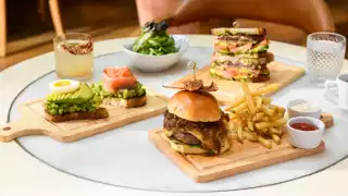 New York City | A hamburger and other menu items at Fig & Olive