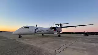 Connect Airlines | The sun sets behind a Connect Airlines plane