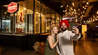 Manitoba restaurants | A couple takes a selfie at a brewery in Manitoba