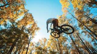 North Carolina | Mountain biker in the air in the mountains of North Carolina