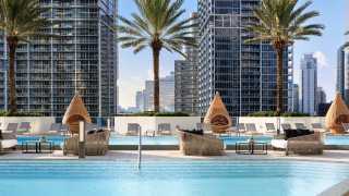 Seating around the rooftop pools at the Kimpton EPIC Miami