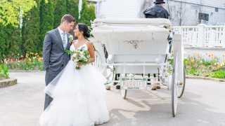 Mackinac Island | A couple looking at each other with a carriage on Mackinac Island