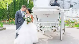 Mackinac Island | A couple looking at each other with a carriage on Mackinac Island