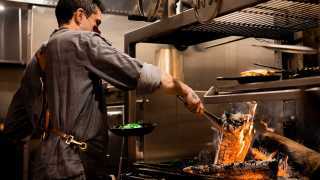Hotel Zed Tofino | A chef cooks over open flames at Roar