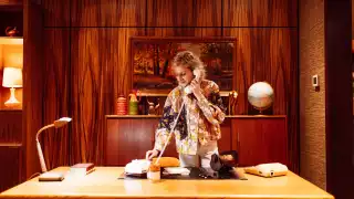 Hotel Zed Tofino | A woman stands at the desk of the 70s office in the lobby