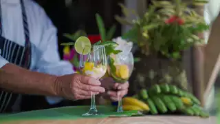 A hand serves smoothies at Liamuiga Farms, a coffee and citrus farm