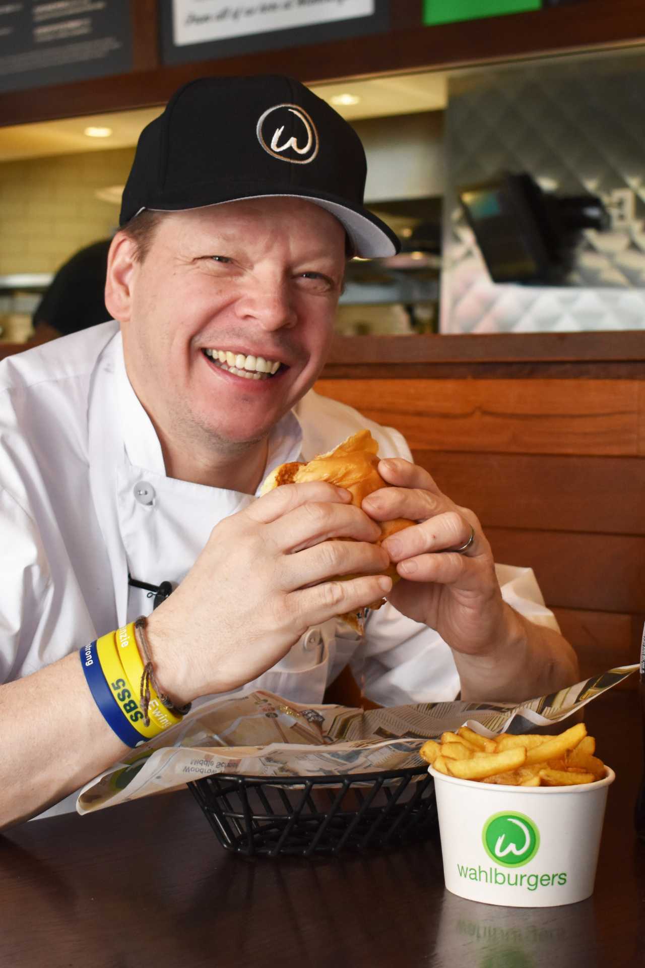 Chef Paul Wahlberg's guide to Boston | Paul Wahlberg eating a Wahlburger