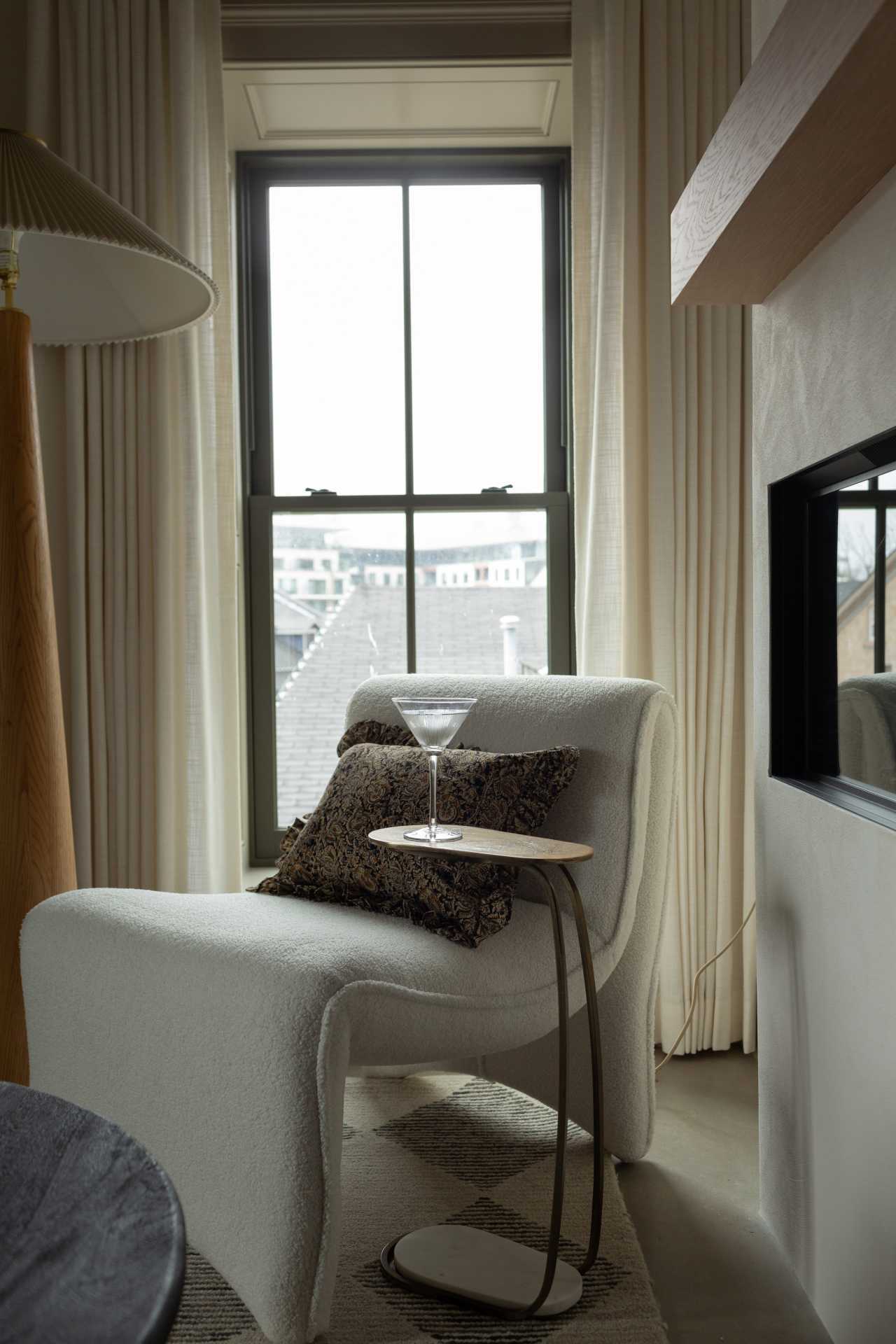 Seating by the fireplace in a guest room at The Kat Florence Hotel