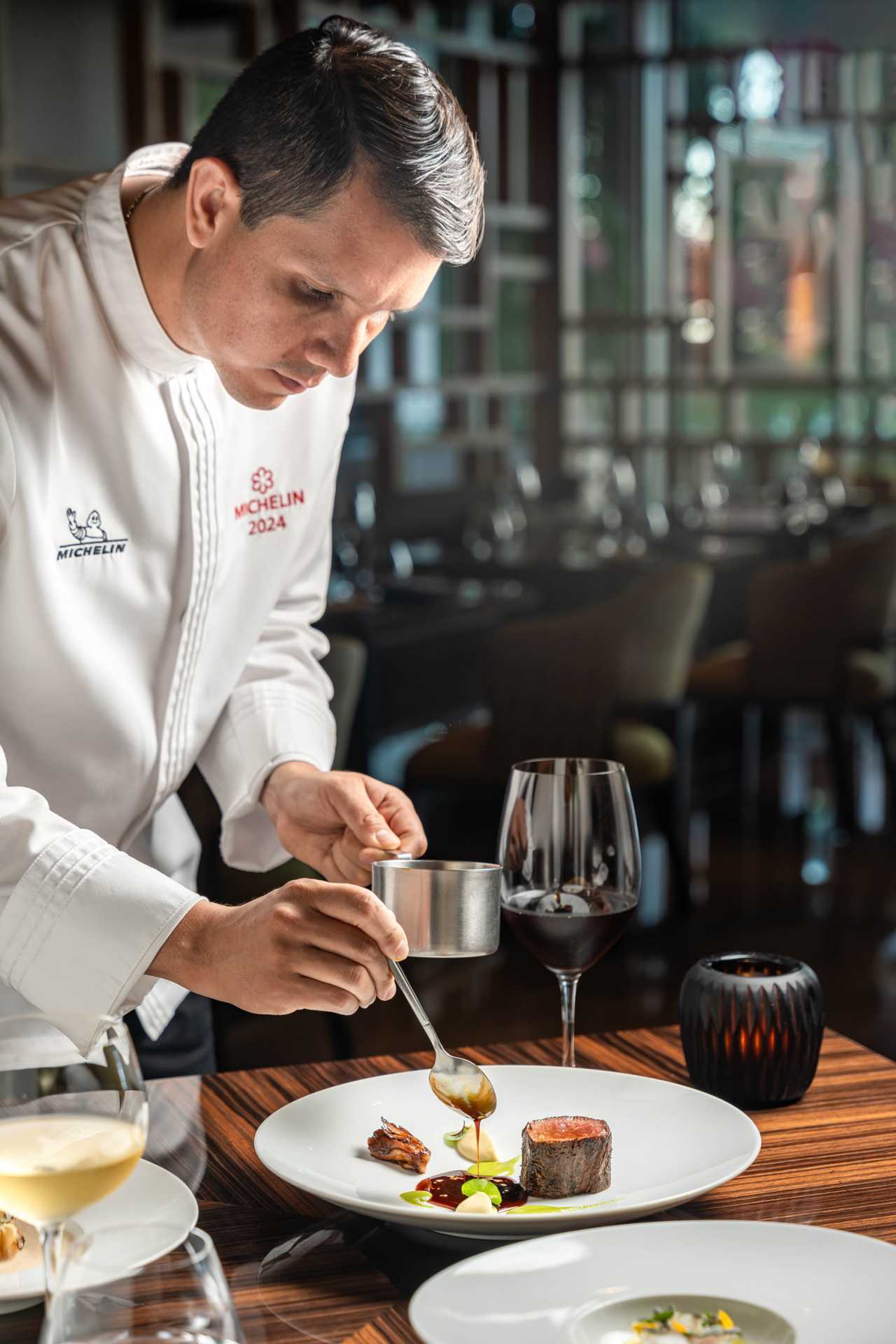 Los Cabos | A chef plates a dish at Cocina de Autor, inside the Grand Velas Resorts, which has one Michelin star