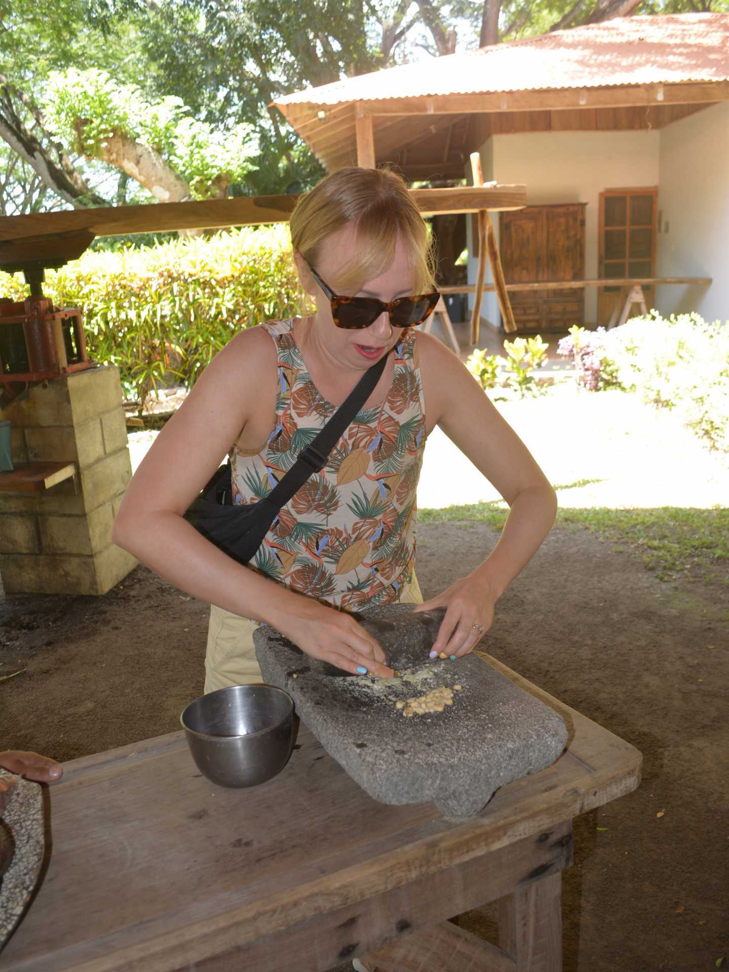 Hacienda Aromal cultural experience in the Papagayo Peninsula, Costa Rica | Editor Katie Bridges grinds corn tortillas by hand