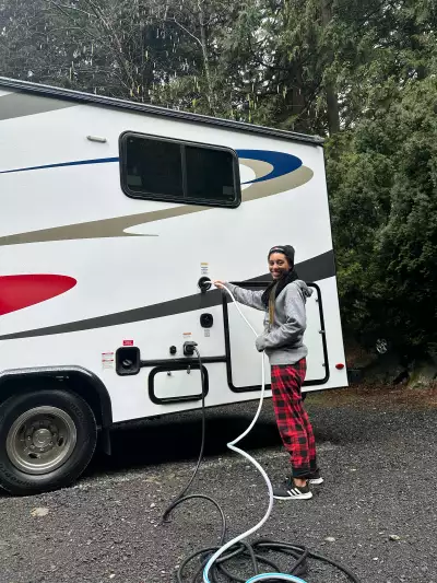 Taylor Newlands filling the water tank of a CanaDream RV