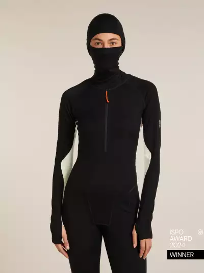 A woman wearing the icebreaker Merino 200 Oasis+ Thermal Suit with hood and mask