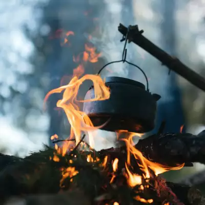 Pot dangling over fire with a fire 'E'