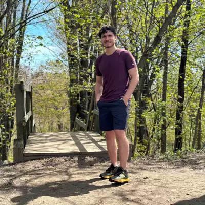 Columbia shoes | A man standing in a forest smiling and wearing Columbia shoes