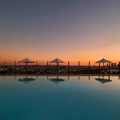 A beautiful pool and sunset with umbrellas in West Hollywood