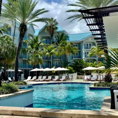 Palm trees, a hotel and pool in the Cayman Islands