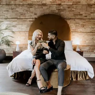 Travel gift ideas | A couple sitting on a bed at Hotel Julie