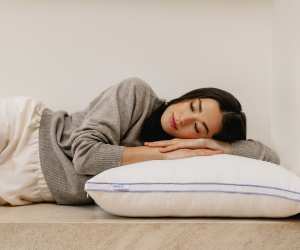 A woman sleeping on The Henrie Adjustable Pillow