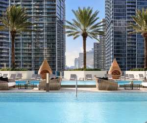 Seating around the rooftop pools at the Kimpton EPIC Miami