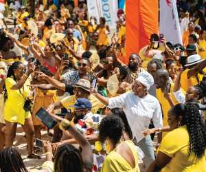 Barbados Rum and Food Festival | A sea of people dressed in yellow at the Rise and Rum Breakfast Beach Party