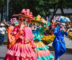 People dressed in costumes at the Día de los Muertos parade in Mexico City