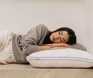 A woman sleeping on The Henrie Adjustable Pillow